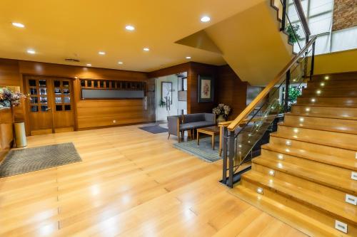 a living room with wooden floors and a staircase at Hotel Alhama in Cintruénigo