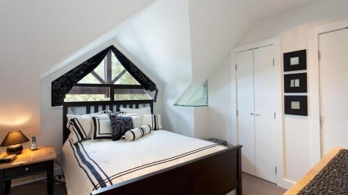 a bedroom with a bed with a large window at Gables 25 - Luxury Townhouse! Walk Everywhere in 5 mins - Whistler Platinum in Whistler