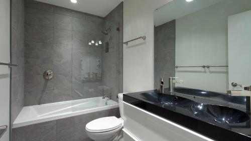 a bathroom with a tub and a toilet and a sink at Gables 25 - Luxury Townhouse! Walk Everywhere in 5 mins - Whistler Platinum in Whistler