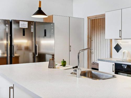 a kitchen with white cabinets and a sink at Luxury Retreat by Beach - By Traum Ferienwohnungen in Marielyst
