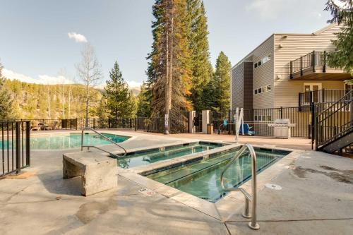 a swimming pool in a yard next to a house at Winter Park Ski-InandSki-Out Condo with Mountain Views in Winter Park