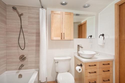 a bathroom with a toilet and a sink and a shower at Snowbird 304 - Beautiful Townhome with Hot Tub & Secure Parking - Whistler Platinum in Whistler