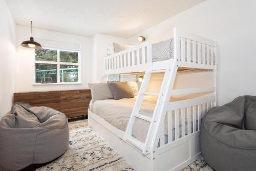 a white bunk bed in a white room with a couch at Snowbird 304 - Beautiful Townhome with Hot Tub & Secure Parking - Whistler Platinum in Whistler