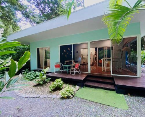a house with a table and chairs in front of it at Ojochal Gardens in Ojochal