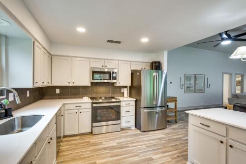 a kitchen with white cabinets and stainless steel appliances at PickleballandSport Court Spacious Kemp Home! in Kemp