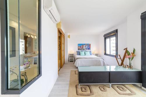 a bedroom with a bed and a glass table at Fantastic penthouse 270m2 with amazing sea views in Roquetas de Mar