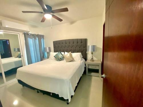 a bedroom with a bed and a ceiling fan at Luxury and Comfort in the heart of Vallarta in Puerto Vallarta