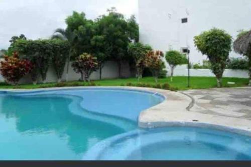 a large swimming pool with blue water in a yard at Luxury and Comfort in the heart of Vallarta in Puerto Vallarta