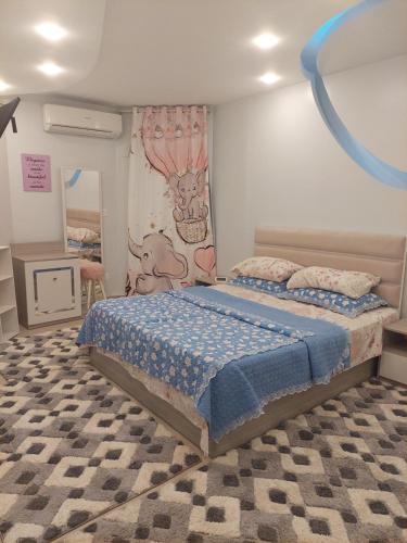 a bedroom with a bed with a blue ribbon on the wall at Your Home Apartment in Alexandria