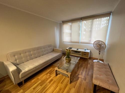 a living room with a couch and a table at Amoblados Chile Rent San Diego in Santiago
