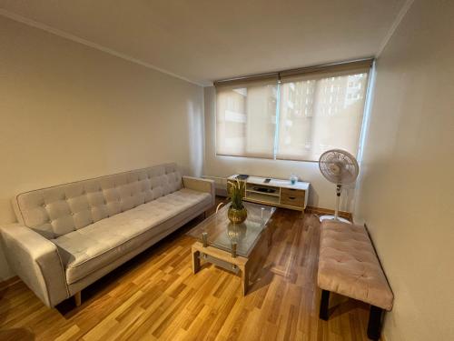 a living room with a couch and a table at Amoblados Chile Rent San Diego in Santiago