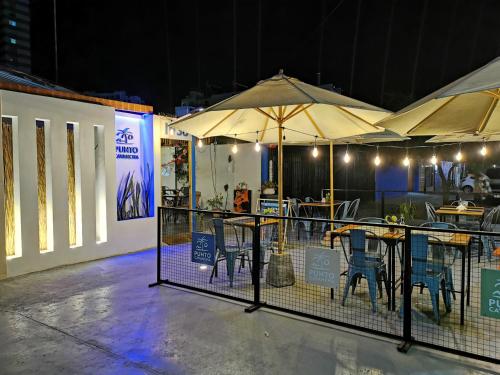 a group of tables with umbrellas and chairs at Hostel Punto Cavancha in Iquique