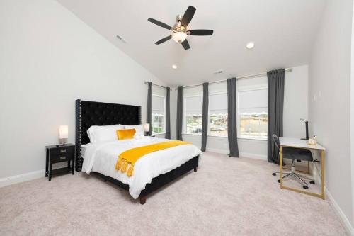 a bedroom with a bed and a ceiling fan at Comfort Plus in Woodbridge