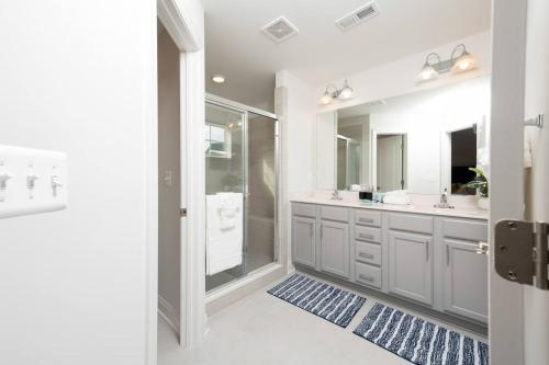 a bathroom with two sinks and a walk in shower at Comfort Plus in Woodbridge
