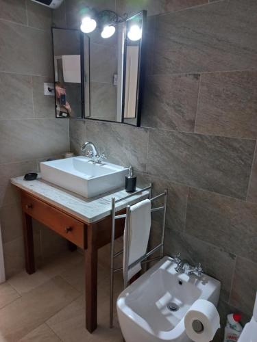 a bathroom with a sink and a toilet at A Casa da Avó Ana in Arneiro das Milhariças