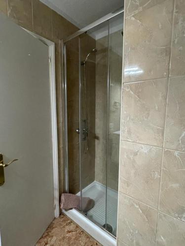 a shower with a glass door in a bathroom at Altemar, two bedrooms las americas in Arona