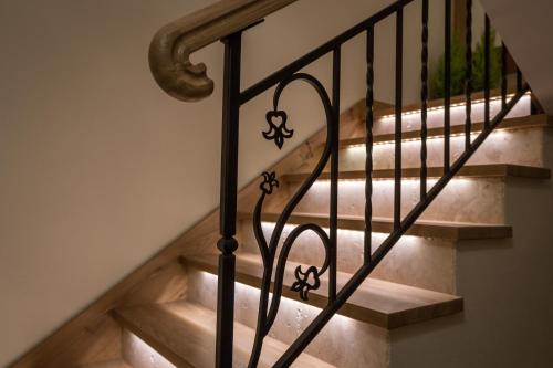 a set of stairs with a wrought iron railing at Aparthotel Bambi in Zakopane