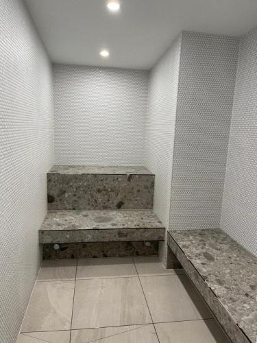 a empty room with two benches in a wall at Rise to the top! in Melbourne