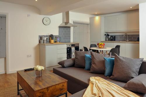 a living room with a couch and a table at Select SA - Queens Terrace in Reading