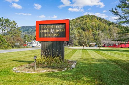 a sign on a pole in the middle of a field at Cedarbrook Queen Suite 106 in Killington