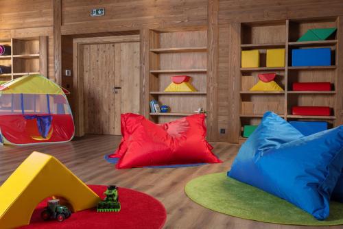 a room with colorful pillows and a play area at Aldrov Resort in Vítkovice
