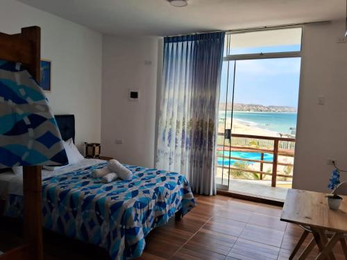 a bedroom with a bed and a view of the ocean at Las Fragatas Casa Hotel Eventos para 40 personas in Canoas De Punta Sal
