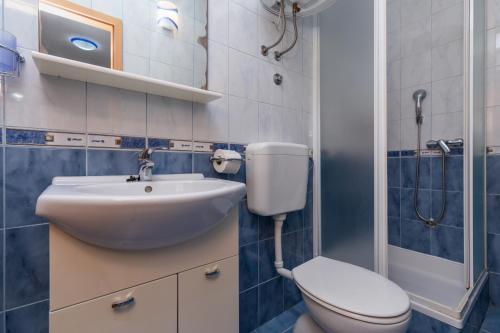 a bathroom with a sink and a toilet at Apartments with parking space Omis - 2745 in Omiš