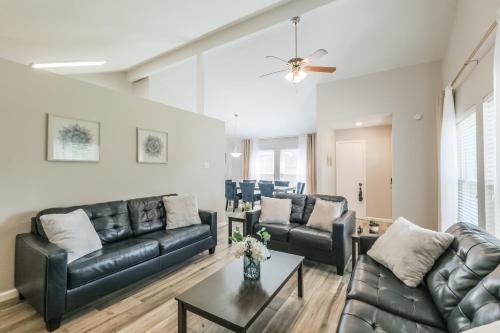 a living room with leather couches and a table at Memorial City Gem Sleeps 12 Fenced Yard in Houston