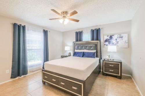a bedroom with a bed and a ceiling fan at 4 Bedroom Near Memorial And City Centre in Houston
