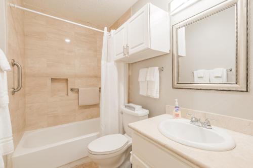 a bathroom with a sink and a toilet and a tub at 4 Bedroom Near Memorial And City Centre in Houston