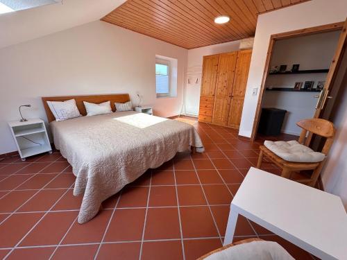 a bedroom with a bed and a tiled floor at Cozy apartment in the Sauerland in Brilon