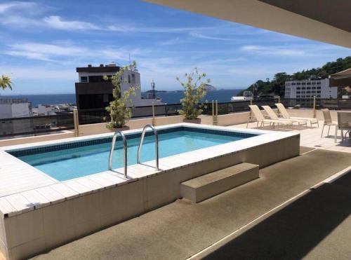 a swimming pool on the roof of a building at Leblon Flat Quarto/ Sala area Nobre in Rio de Janeiro