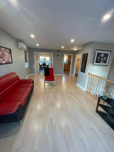 a living room with a red couch and a table at Armdale Urban Lodge, Dine & Stay in Halifax