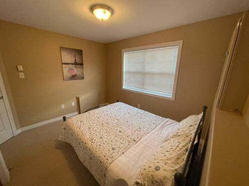 a bedroom with a bed and a window at Armdale Urban Lodge, Dine & Stay in Halifax