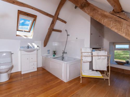 a bathroom with a sink and a tub and a toilet at Lighthouse Watch in Saint Nicholas