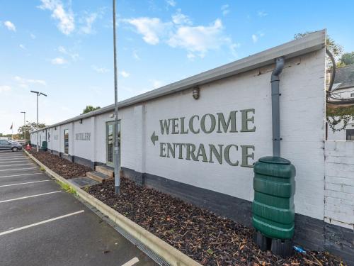 a building with a welcome entrance on the side of it at Oak - Uk45519 in Humberstone