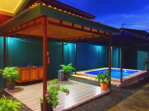 a house with a swimming pool in the backyard at Arenal Palacios in Fortuna
