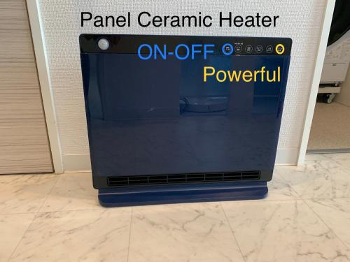 a sign that reads pained ceramic heater on off powerless at O2 capsule house OTARU in Otaru