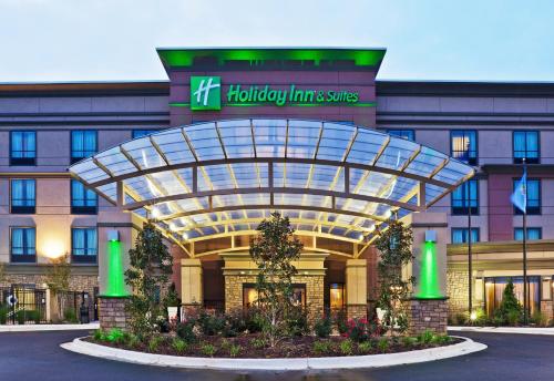 a front view of a hotel with a building at Holiday Inn & Suites Stillwater-University West by IHG in Stillwater