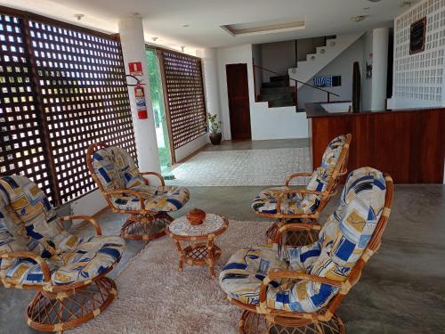 a group of chairs and a table in a room at Paradise Beach in Fortim