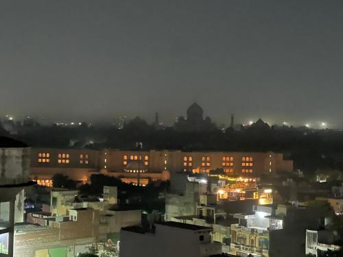 a view of a city at night with buildings at Luxury Penthouse with Taj Mahal view in Agra