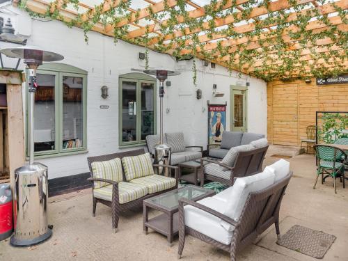 a patio with couches and chairs and a table at Shetland - Uk45521 in Humberstone