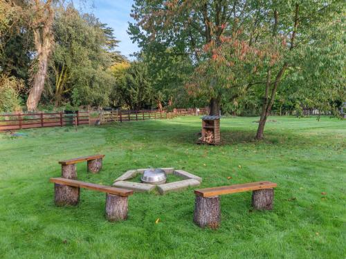 a park with benches and a fire pit in the grass at Shetland - Uk45521 in Humberstone