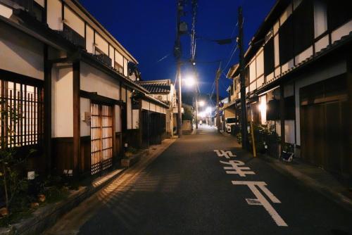 an empty street in an asian city at night at naramachiの宿 自助入住 请看邮件 in Nara