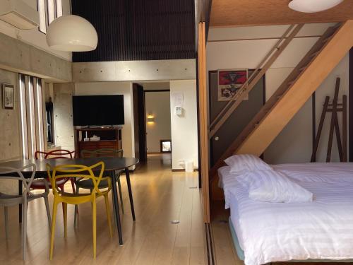 a bedroom with a bed and a table and a dining room at naramachiの宿 自助入住 请看邮件 in Nara