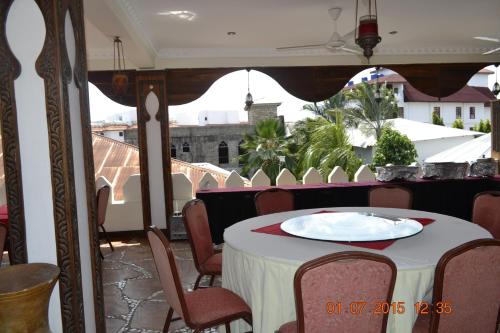 a table with a white plate on top of a balcony at Al-Minar Hotel in Zanzibar City