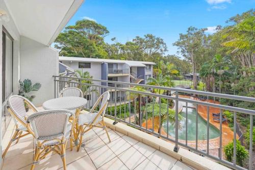 a balcony with chairs and a table and a view at Flynns Beach Resort - Port Macquarie beachside apartment - Flynn114 in Port Macquarie