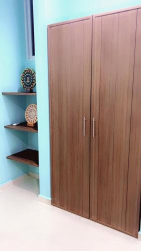 a pair of wooden cabinets in a room at Chicxulub Puerto Beach Penthouse in Chicxulub