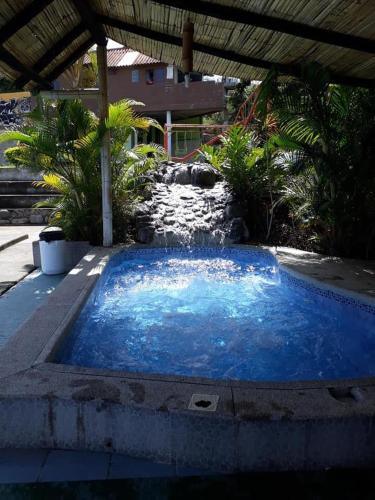 a large blue swimming pool in a yard at Hosteria Cercaloma in Santa Isabel