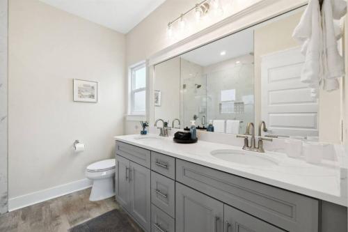 a white bathroom with a sink and a toilet at Laguna Beach House with a Game Room in Panama City Beach